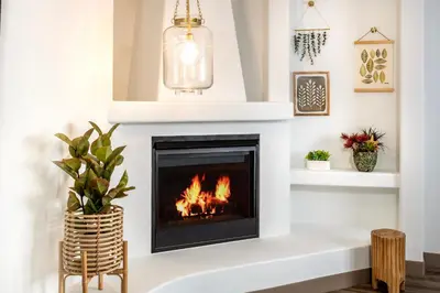 a fireplace in a living room with a fire in it at Cardiff By The Sea Lodge in Encinitas