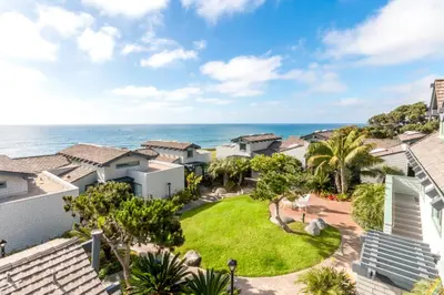 an aerial view of a house with the ocean in the background at Wave Crest Resort in San Diego