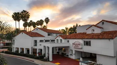 a hotel with white buildings and palm trees at Casablanca Inn in San Clemente