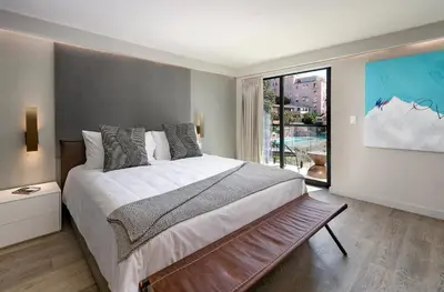 a bedroom with a large bed and a large window at La Jolla Cove Suites in San Diego