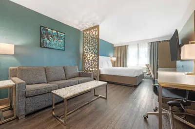 a hotel room with a couch and a bed at Best Western Plus Temecula Wine Country Hotel & Suites in Temecula
