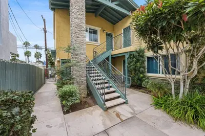 a house with a staircase in front of it at Ocean Beach Pier Condo in San Diego