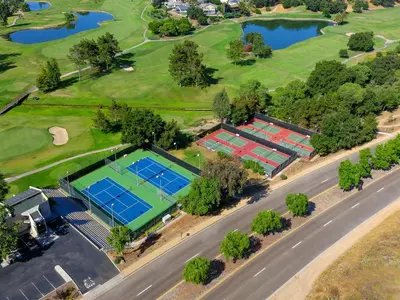 an overhead view of tennis courts on a golf course at San Vicente Golf Resort in Ramona