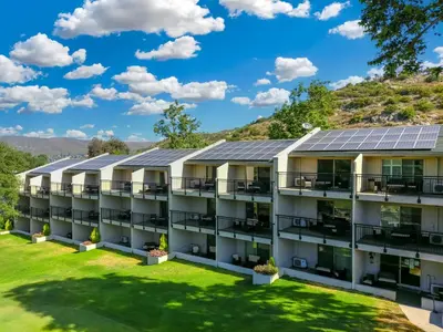 an image of an apartment building with solar panels at San Vicente Golf Resort in Ramona