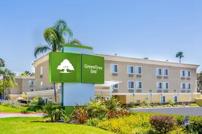a building with a sign for the consulate inn at GreenTree Inn San Diego Mission Bay in San Diego
