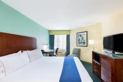 a hotel room with a bed and a flat screen tv at GreenTree Inn San Diego Mission Bay in San Diego