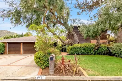 a house with a yard with a driveway at Sunny Dreams Home in San Diego