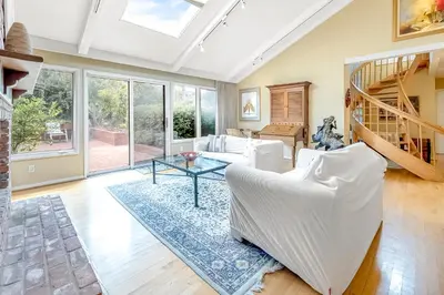 a living room with a white couch and a table at Sunny Dreams Home in San Diego