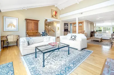 a living room with white couches and a table at Sunny Dreams Home in San Diego