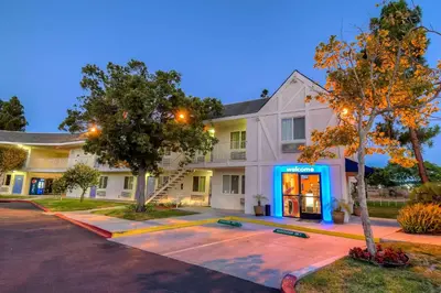a house with a blue door in front of it at Motel 6-San Diego, CA - North in San Diego