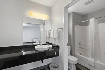 a white bathroom with a sink and a toilet at Motel 6-San Diego, CA - North in San Diego