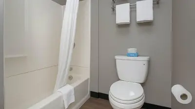 a bathroom with a white toilet and a tub and a shower at Motel 6-San Diego, CA - Downtown in San Diego