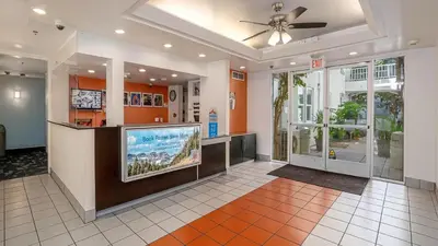 a lobby with a large flat screen tv and a bar at Motel 6-San Diego, CA - Downtown in San Diego