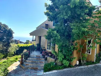 a house with a staircase leading up to a house at Rent Laguna Beach Sanctuary in Laguna Beach