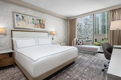 a hotel room with a white bed and a desk at InterContinental San Diego by IHG in San Diego