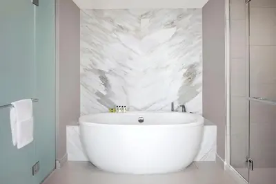 a bathroom with a large white tub in a room at InterContinental San Diego by IHG in San Diego