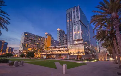 a city skyline with tall buildings and a palm tree at InterContinental San Diego by IHG in San Diego