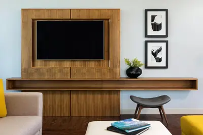 a living room with a television and a chair at InterContinental San Diego by IHG in San Diego