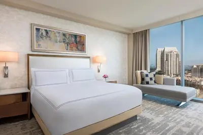 a bedroom with a large white bed and a couch at InterContinental San Diego by IHG in San Diego