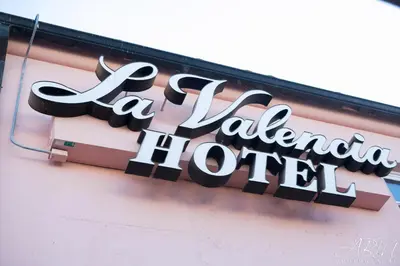 a sign for a laader hotel on the side of a building at La Valencia Hotel in San Diego