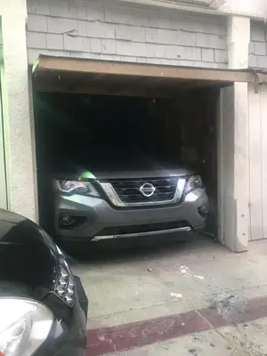 a car is parked inside of a garage at Fantastic Mission Beach condo steps to the Beach in San Diego