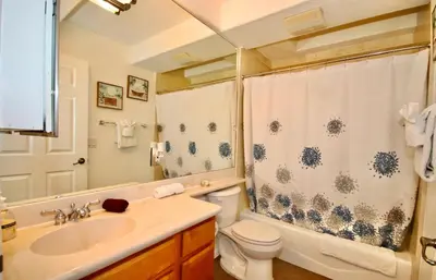 a bathroom with a sink and a toilet and a shower at Little Italy Modern Lofts in San Diego