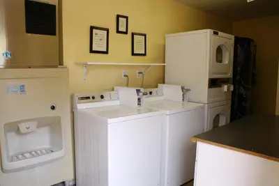 a laundry room with white appliances in a room at Crown City Inn Coronado in San Diego