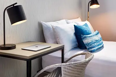 a bedroom with a bed with a table and a laptop at Pacific View Inn in San Diego