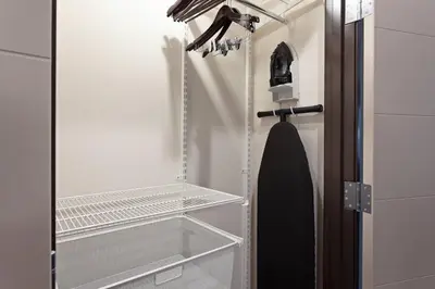 a walk in closet with a glass door and a tie at TownePlace Suites by Marriott San Diego Central in San Diego