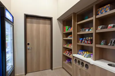a hallway with a door and shelves with food at TownePlace Suites by Marriott San Diego Central in San Diego