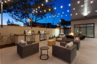a patio with couches and a bar with lights at TownePlace Suites by Marriott San Diego Central in San Diego