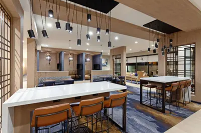 a lobby with a bar with chairs and tables at TownePlace Suites by Marriott San Diego Central in San Diego