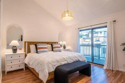 a bedroom with a bed and a large window at Luxury Retreat • Hot Tub FirePit Panoramic Views in San Diego