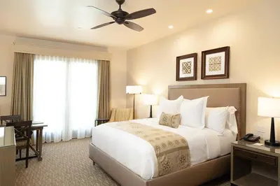 a bedroom with a large bed with a ceiling fan at Ponte Vineyard Inn in Temecula
