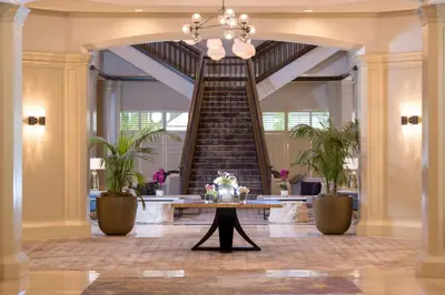 a spiral staircase in a lobby with a table at DoubleTree by Hilton San Diego-Mission Valley in San Diego