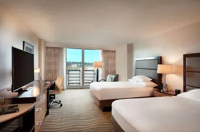 a hotel room with two beds and a flat screen tv at DoubleTree by Hilton San Diego-Mission Valley in San Diego
