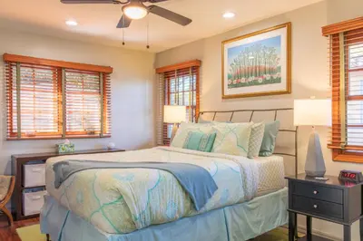 a bedroom with a bed and a ceiling fan at The Little Pumpkin Guest House in San Diego