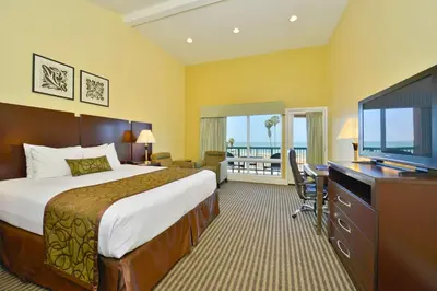 a hotel room with a bed and a flat screen tv at Best Western Plus Dana Point Inn-by-the-Sea in Dana Point