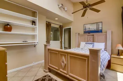 a bedroom with a bed and a ceiling fan at PACIFIC BEACH MANSION in San Diego