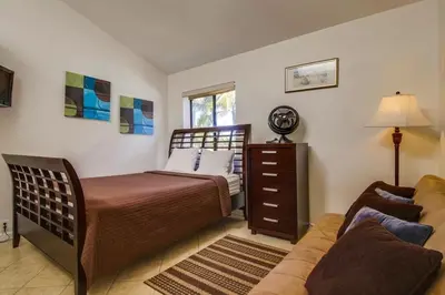 a bedroom with a bed and a couch at PACIFIC BEACH MANSION in San Diego