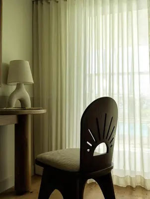 a chair sitting in front of a window at Casa Loma Beach Hotel in Laguna Beach