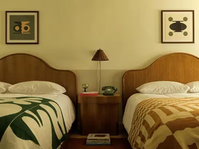a hotel room with two beds and a lamp at Casa Loma Beach Hotel in Laguna Beach