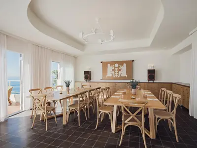 a dining room with wooden tables and chairs at Casa Loma Beach Hotel in Laguna Beach