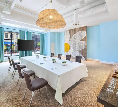 a conference room with a large white table and chairs at Margaritaville Hotel San Diego Gaslamp Quarter in San Diego