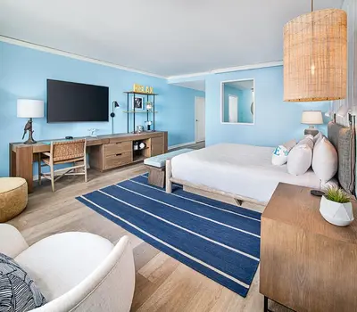 a bedroom with a large bed and a tv at Margaritaville Hotel San Diego Gaslamp Quarter in San Diego