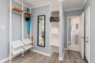 a dressing room with white cabinets and a mirror at Pacific Bungalow in Oceanside with Backyard & Tiny House in Oceanside
