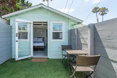 a small blue house with two chairs and a table at Pacific Bungalow in Oceanside with Backyard & Tiny House in Oceanside