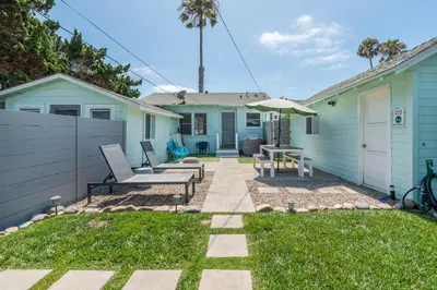 a patio with a table and chairs and an umbrella at Pacific Bungalow in Oceanside with Backyard & Tiny House in Oceanside