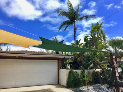 a green and yellow umbrella hanging over a garage at Kaza Kokos in Oceanside
