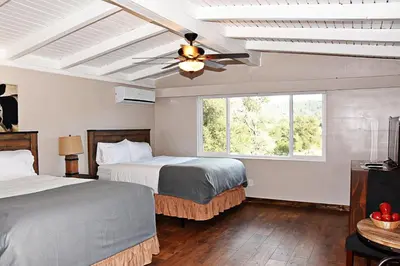 a bedroom with two beds and a ceiling fan at Apple Tree Inn in Julian